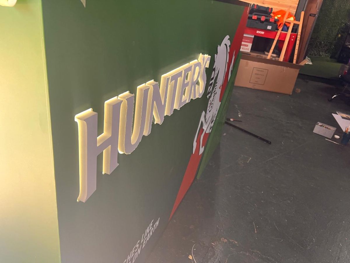 Hunters 3D gold lettering with a lion emblem on a green panel