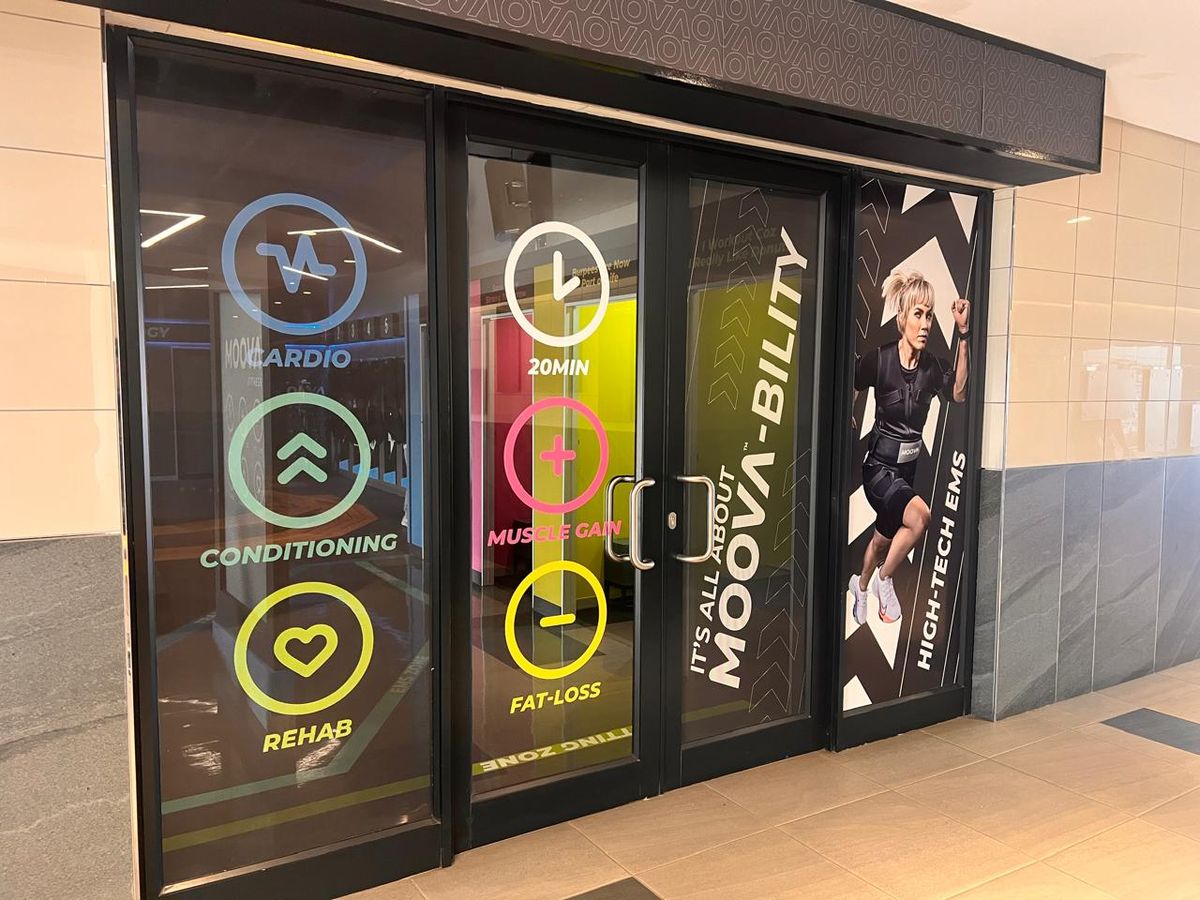 Gym entrance glass doors covered with colourful printed window graphics