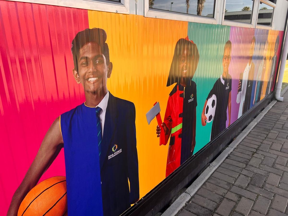 Close-up of a printed wall mural with a student holding a basketball