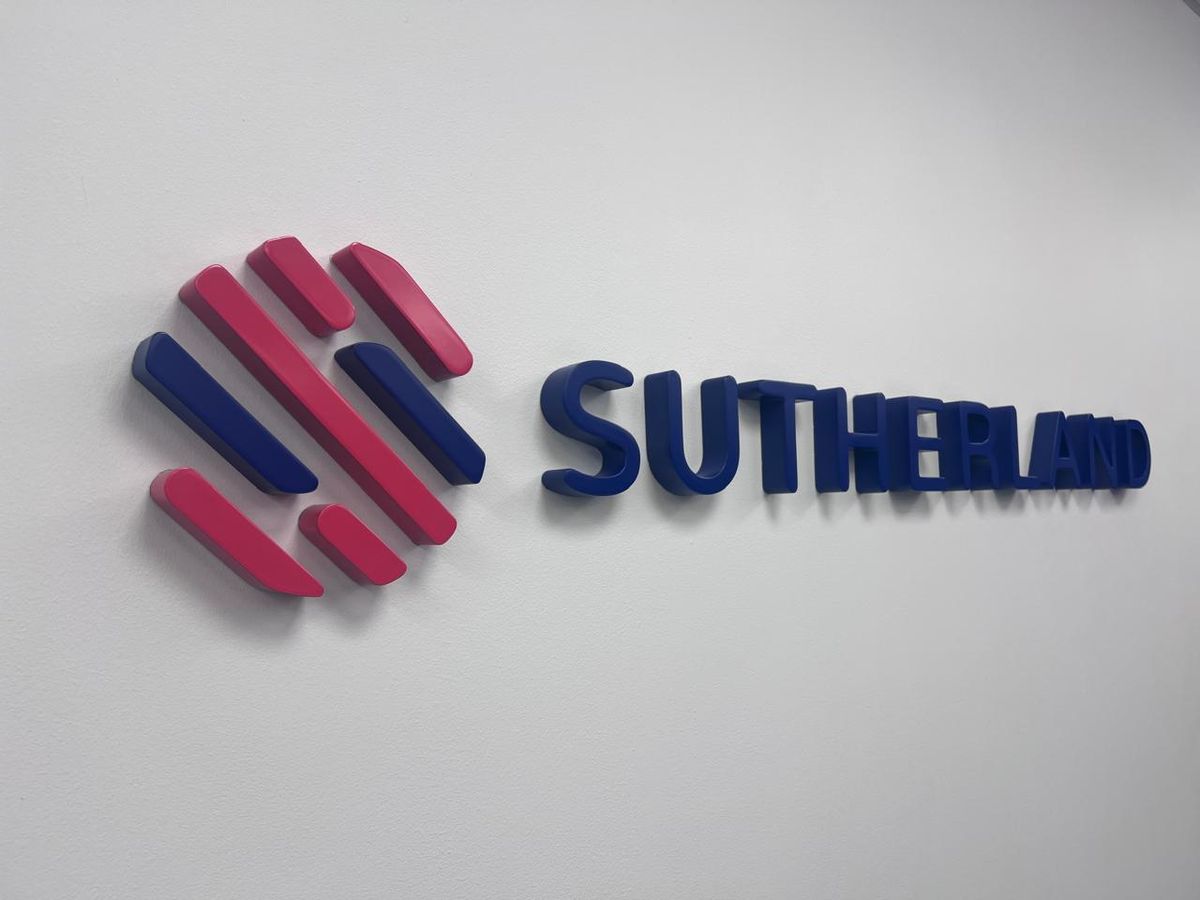 Sutherland 3D reception logo mounted on a white wall
